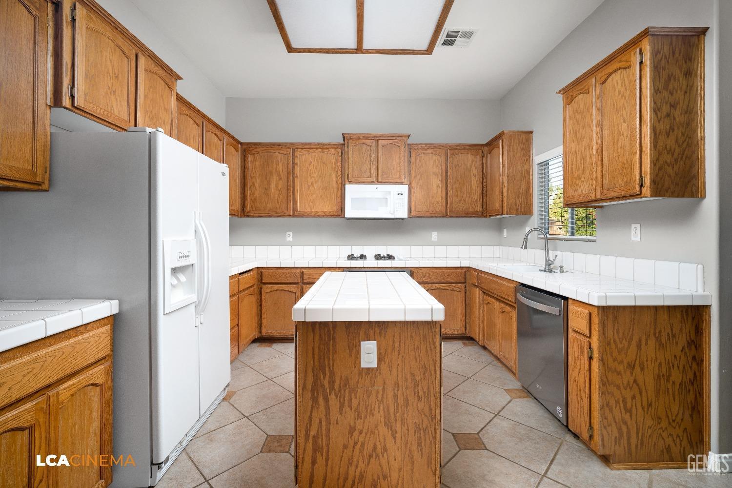 Undisclosed Address Bakersfield, CA 93312 - Photo 12 of 21 a kitchen with a sink a counter top space and cabinets