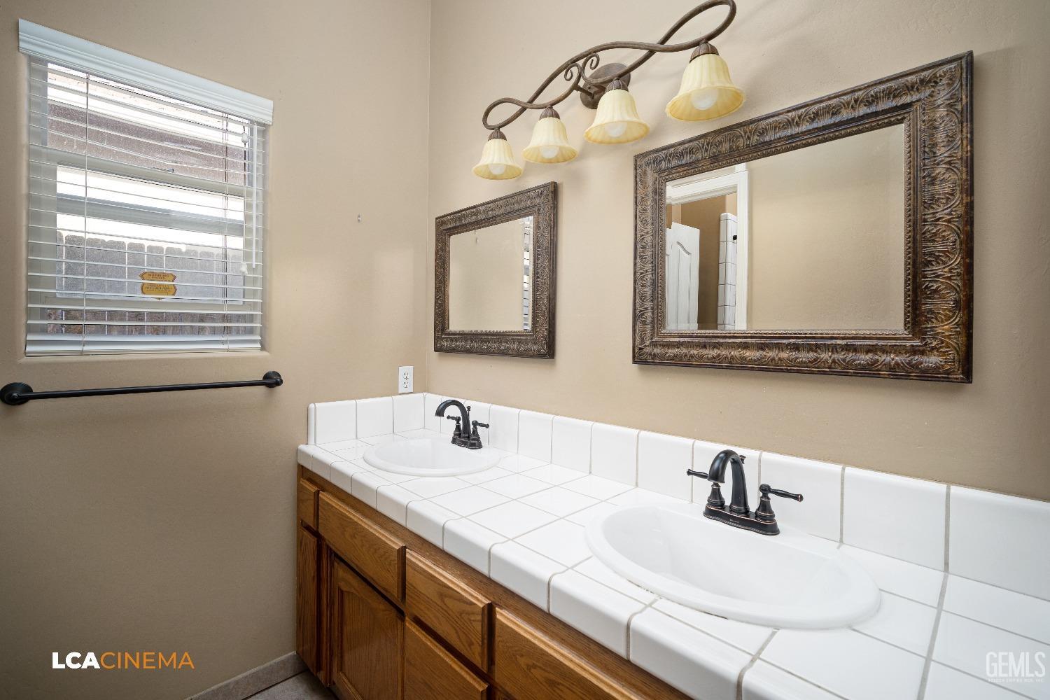 Undisclosed Address Bakersfield, CA 93312 - Photo 15 of 21 a bathroom with a sink and a mirror
