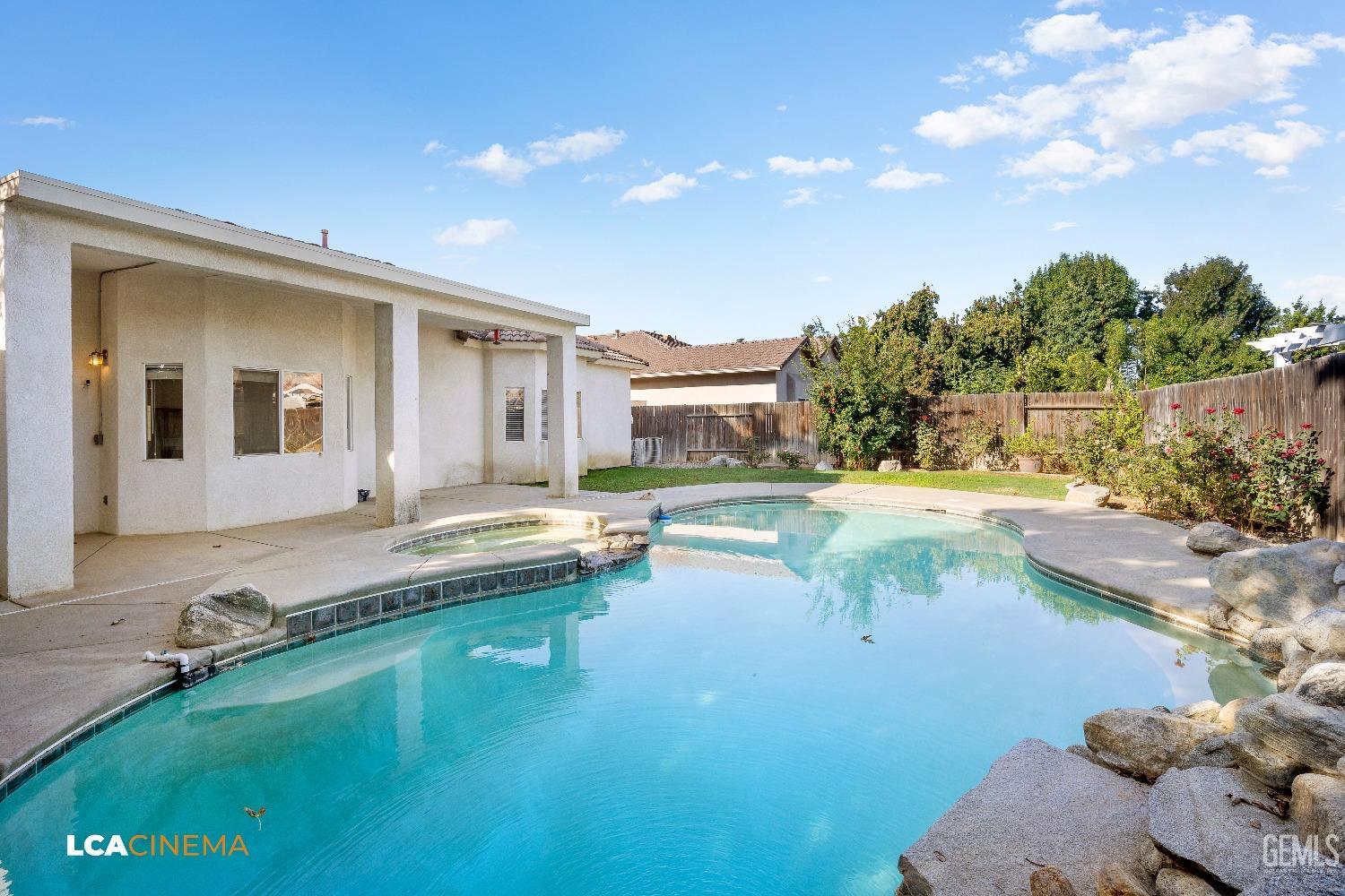 Undisclosed Address Bakersfield, CA 93312 - Photo 21 of 21 a view of an house with swimming pool and yard