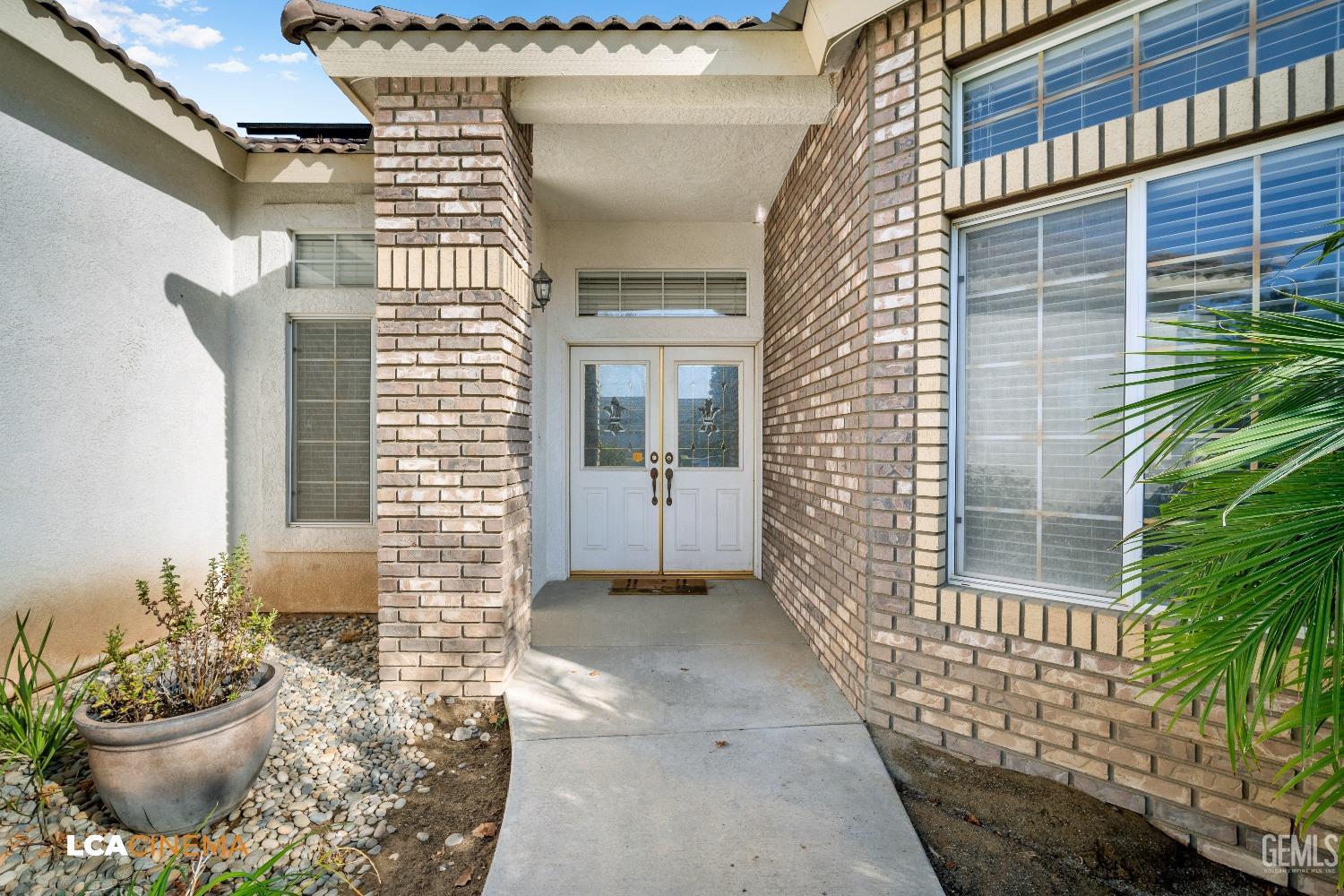 Undisclosed Address Bakersfield, CA 93312 - Photo 5 of 21 a view of a porch with a chair and potted plants