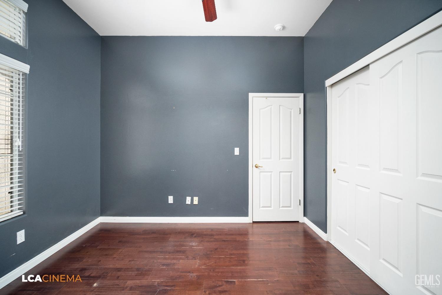 Undisclosed Address Bakersfield, CA 93312 - Photo 8 of 21 an empty room with wooden floor and windows
