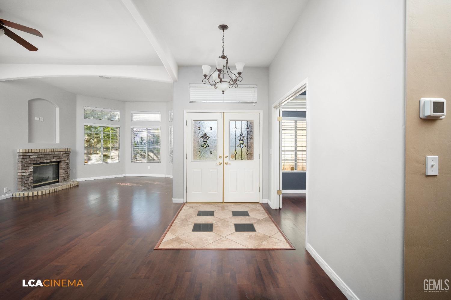 Undisclosed Address Bakersfield, CA 93312 - Photo 9 of 21 a living room with hard wood floors and a fireplace