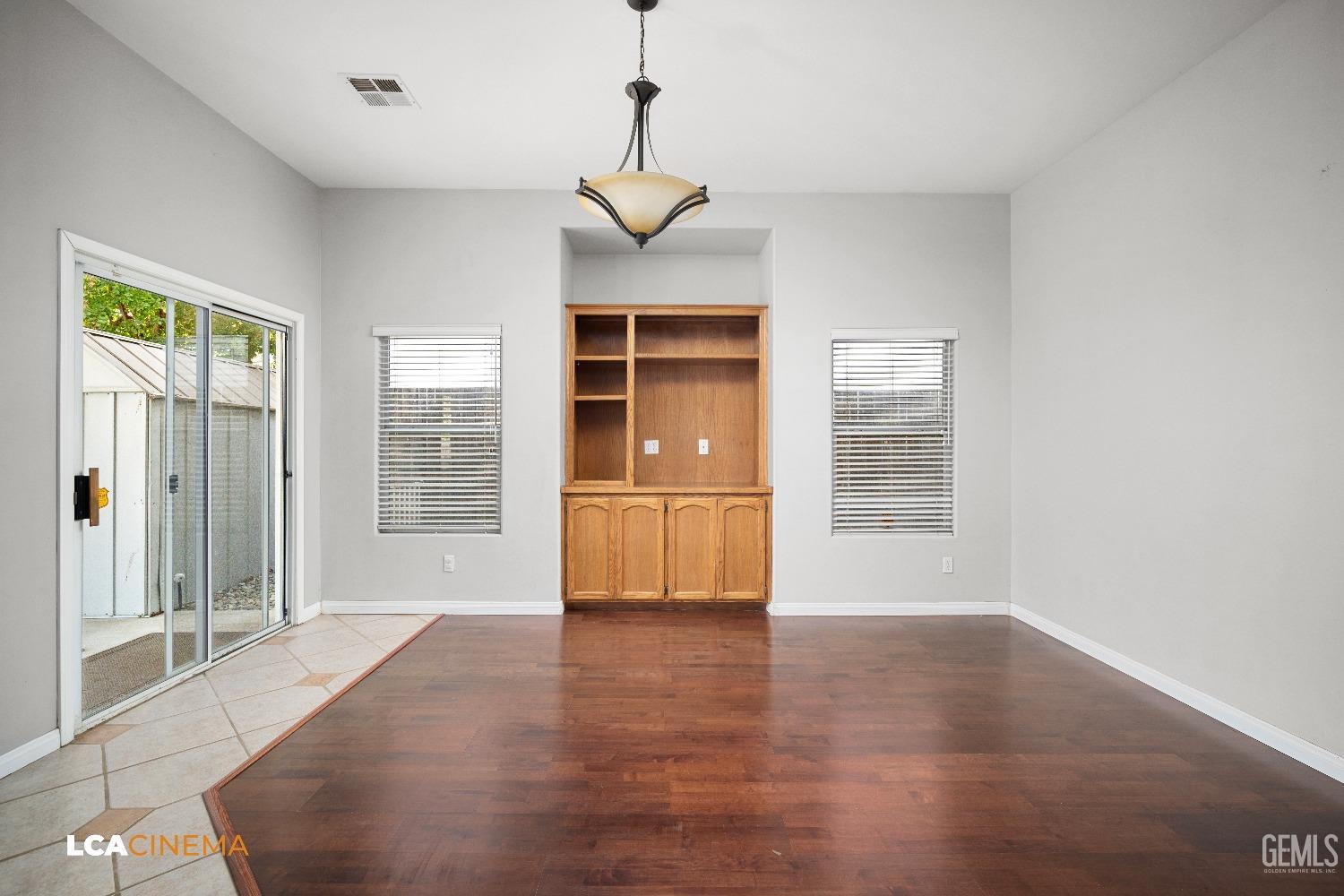 Undisclosed Address Bakersfield, CA 93312 - Photo 10 of 21 a view of an empty room with a window and wooden floor