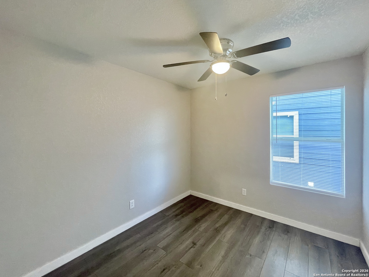 6938 Crestway Road, Unit 1 San Antonio, TX 78239 - Photo 13 of 16 wooden floor in an empty room with a window