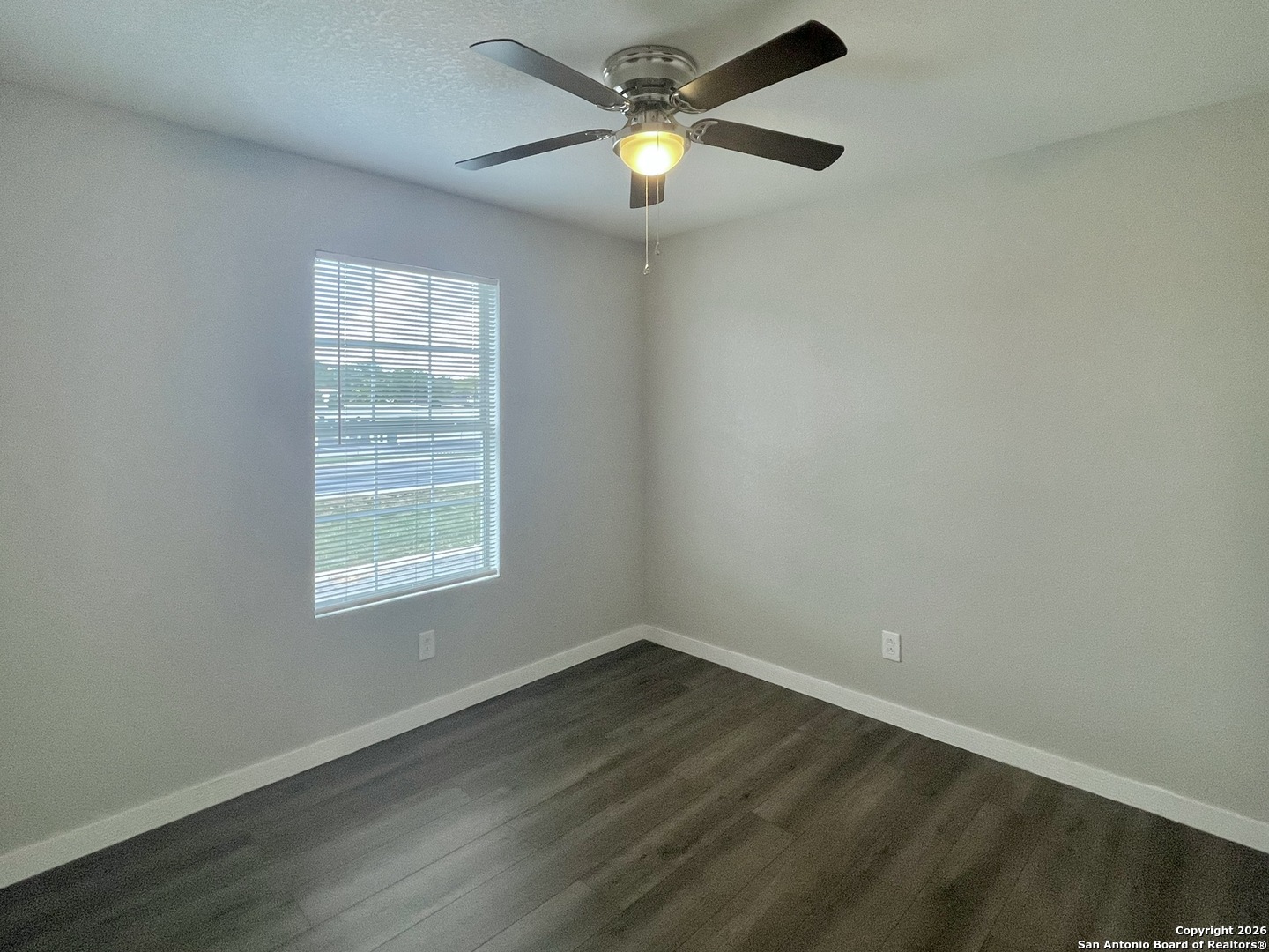 6938 Crestway Road, Unit 1 San Antonio, TX 78239 - Photo 16 of 16 an empty room with a window and a fan