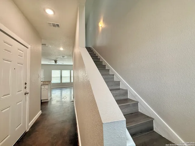 a view of entryway and hall with wooden floor