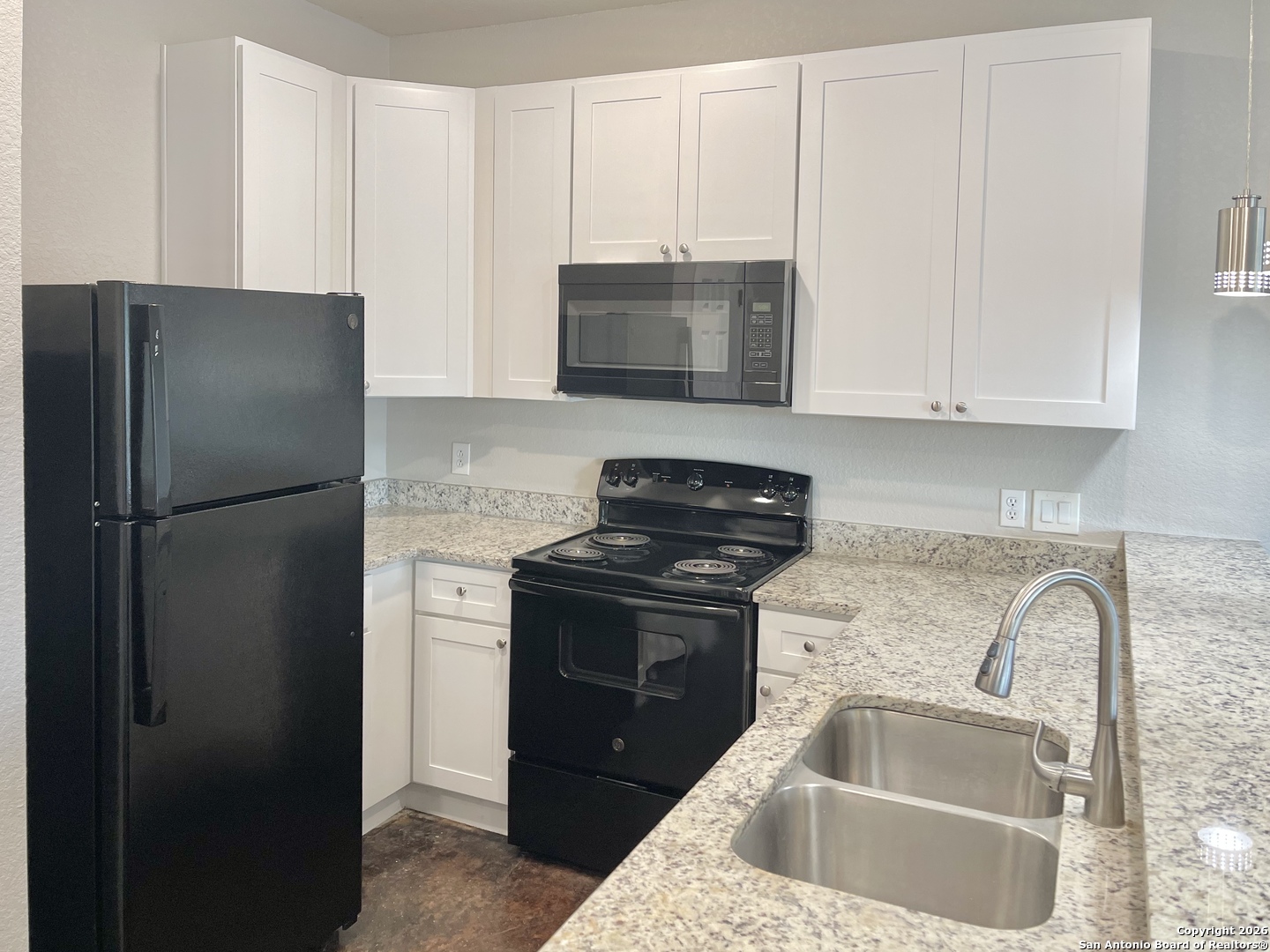 6938 Crestway Road, Unit 1 San Antonio, TX 78239 - Photo 6 of 16 a kitchen with a refrigerator sink and cabinets