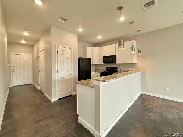 a view of kitchen with stainless steel appliances refrigerator oven and microwave