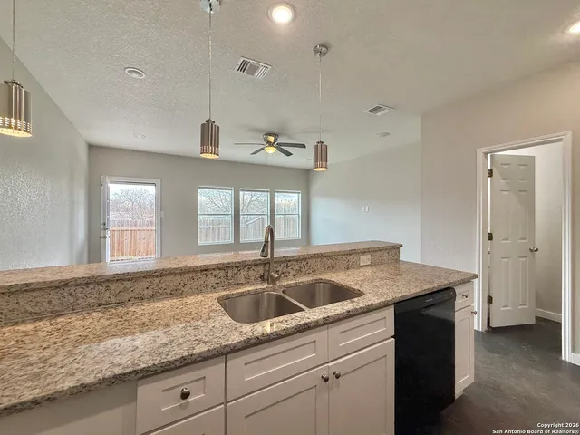 a kitchen with a sink and cabinets