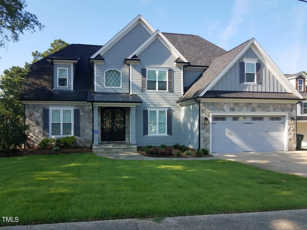 721 Shelley Road Raleigh, NC 27609 - Photo 1 of 46 a front view of a house with a garden and yard