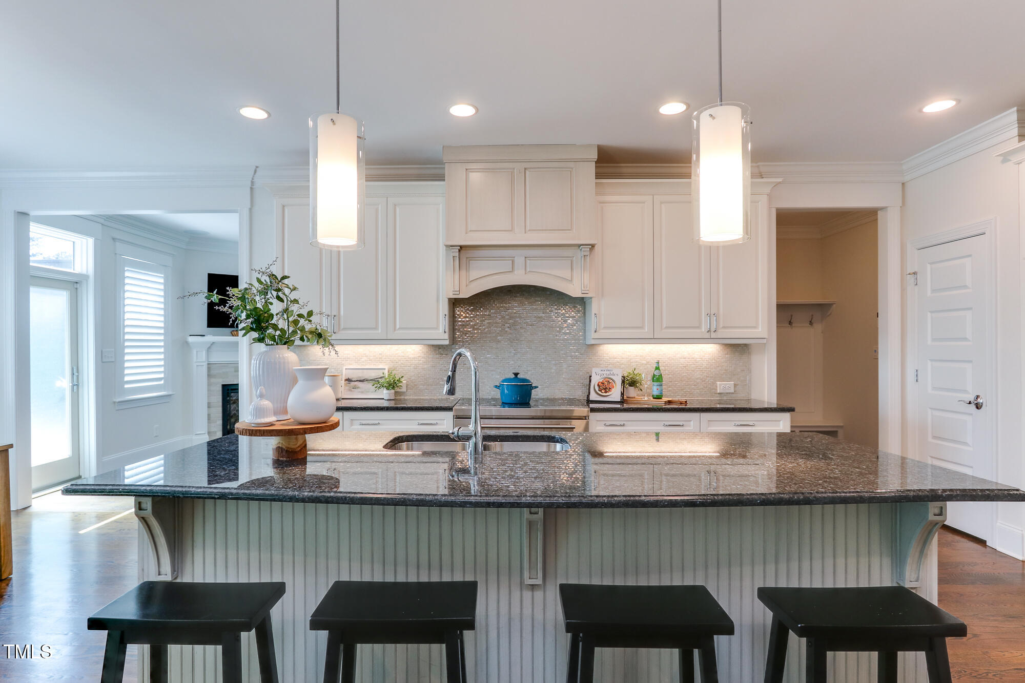 721 Shelley Road Raleigh, NC 27609 - Photo 12 of 46 a kitchen with granite countertop white cabinets and chairs