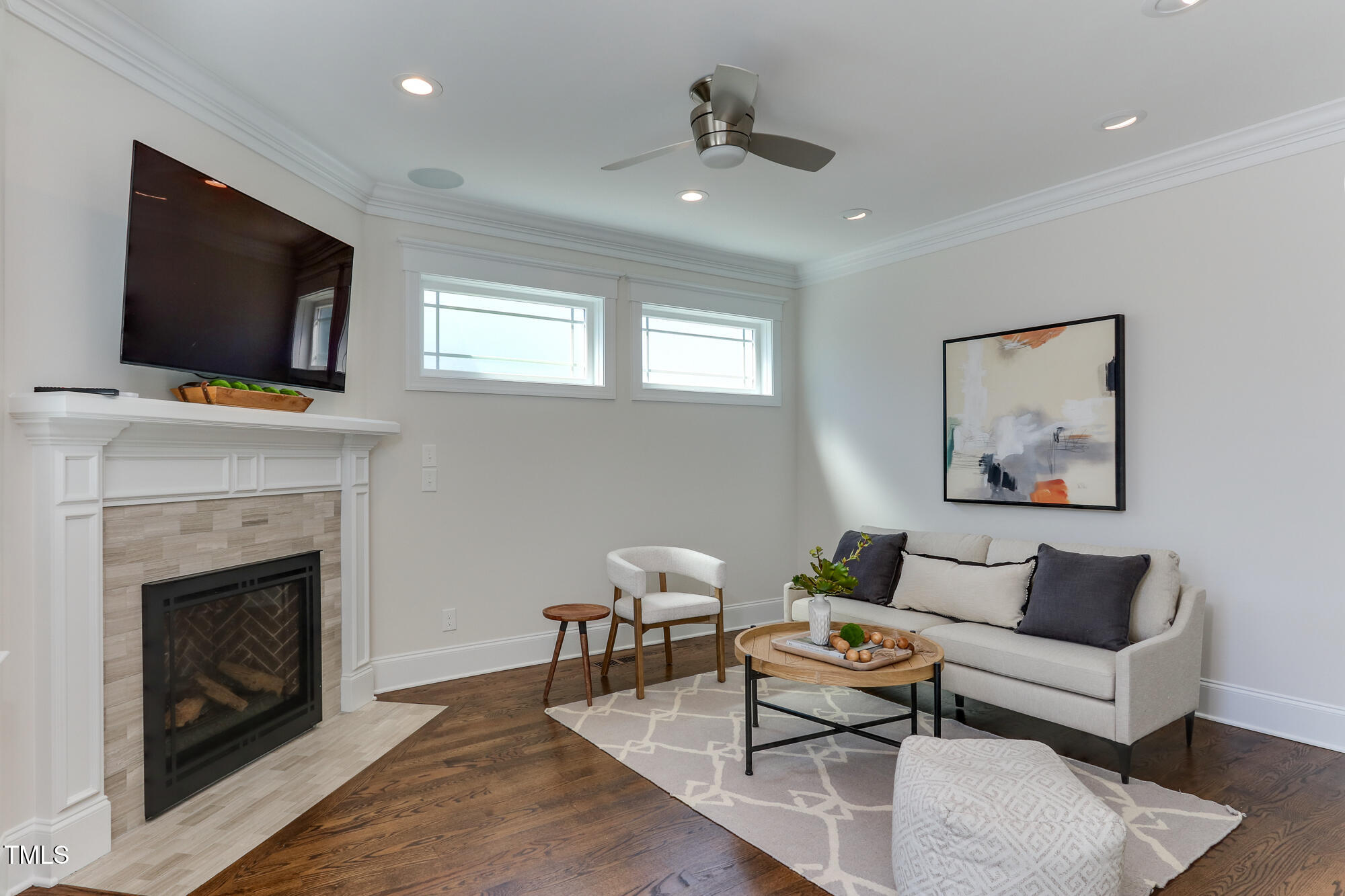 721 Shelley Road Raleigh, NC 27609 - Photo 15 of 46 a living room with furniture a flat screen tv and a fireplace