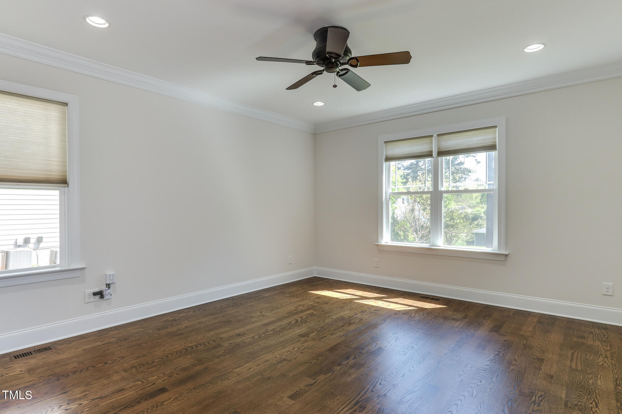 721 Shelley Road Raleigh, NC 27609 - Photo 19 of 46 a view of empty room with wooden floor and fan