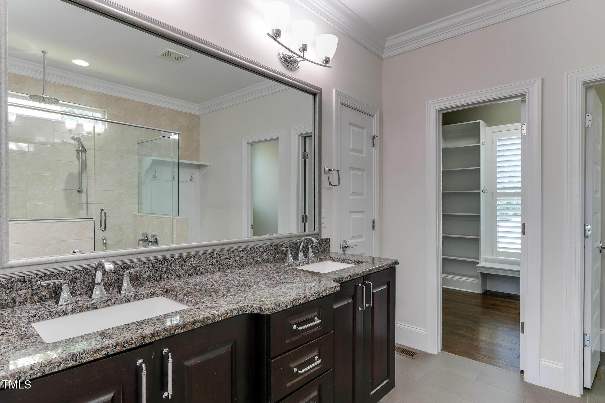 721 Shelley Road Raleigh, NC 27609 - Photo 21 of 46 a bathroom with a granite countertop sink double and mirror