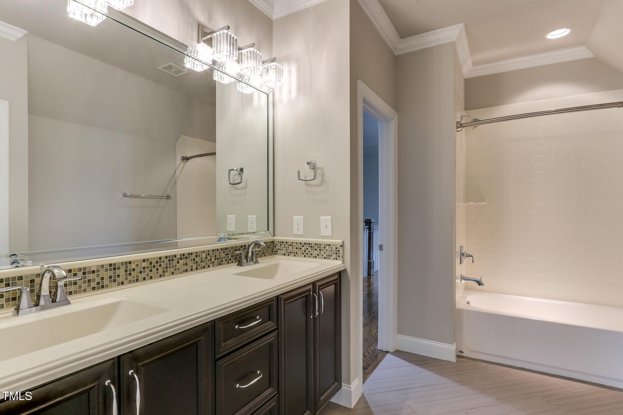 721 Shelley Road Raleigh, NC 27609 - Photo 29 of 46 a bathroom with a granite countertop sink a mirror and a shower