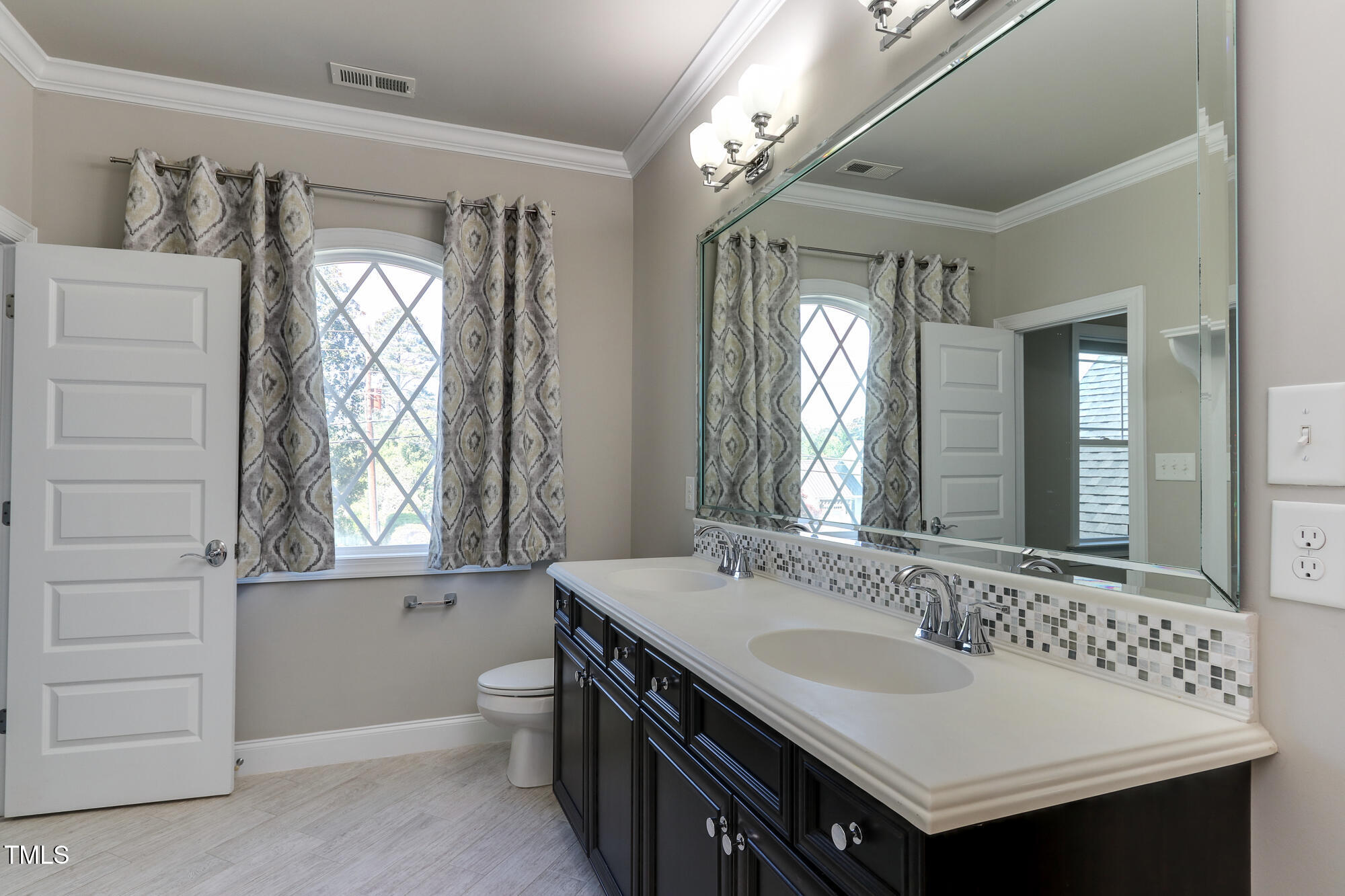 721 Shelley Road Raleigh, NC 27609 - Photo 32 of 46 a bathroom with a sink double vanity and a mirror