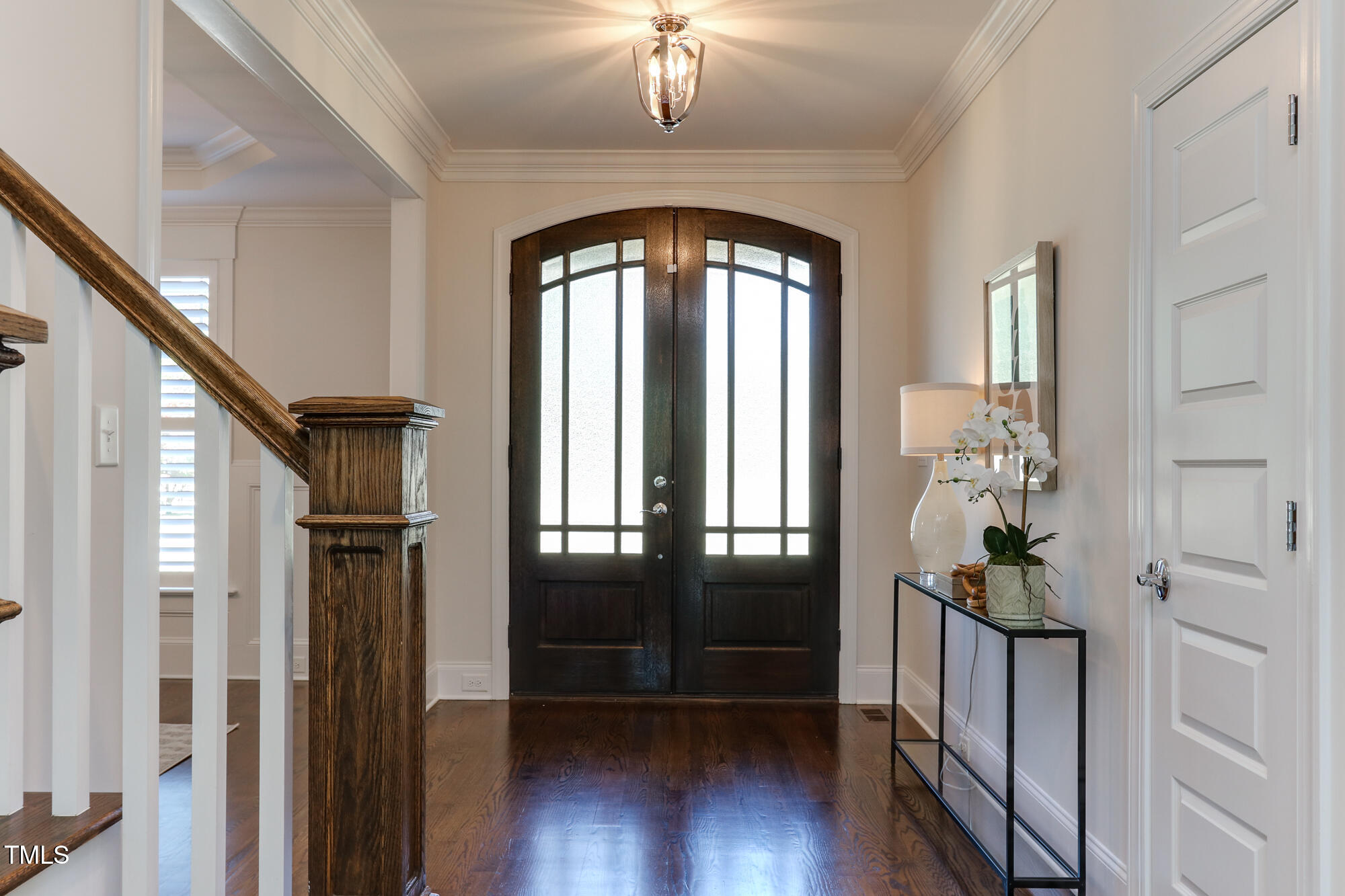 721 Shelley Road Raleigh, NC 27609 - Photo 5 of 46 a hallway with wooden floor chandelier and livingroom