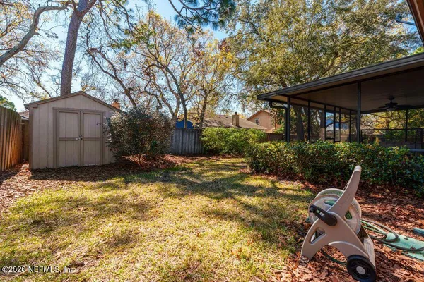 a view of backyard with swimming pool and furniture