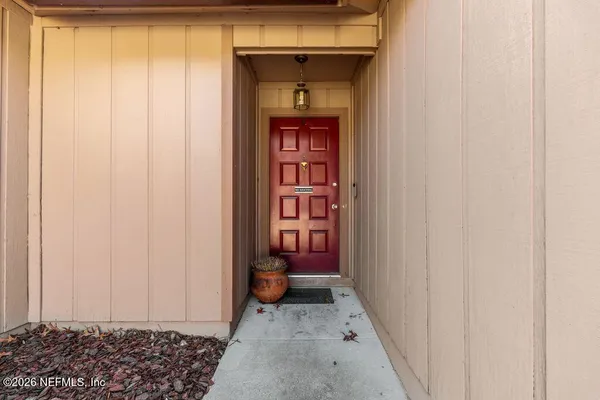 a view of a hallway with entryway door