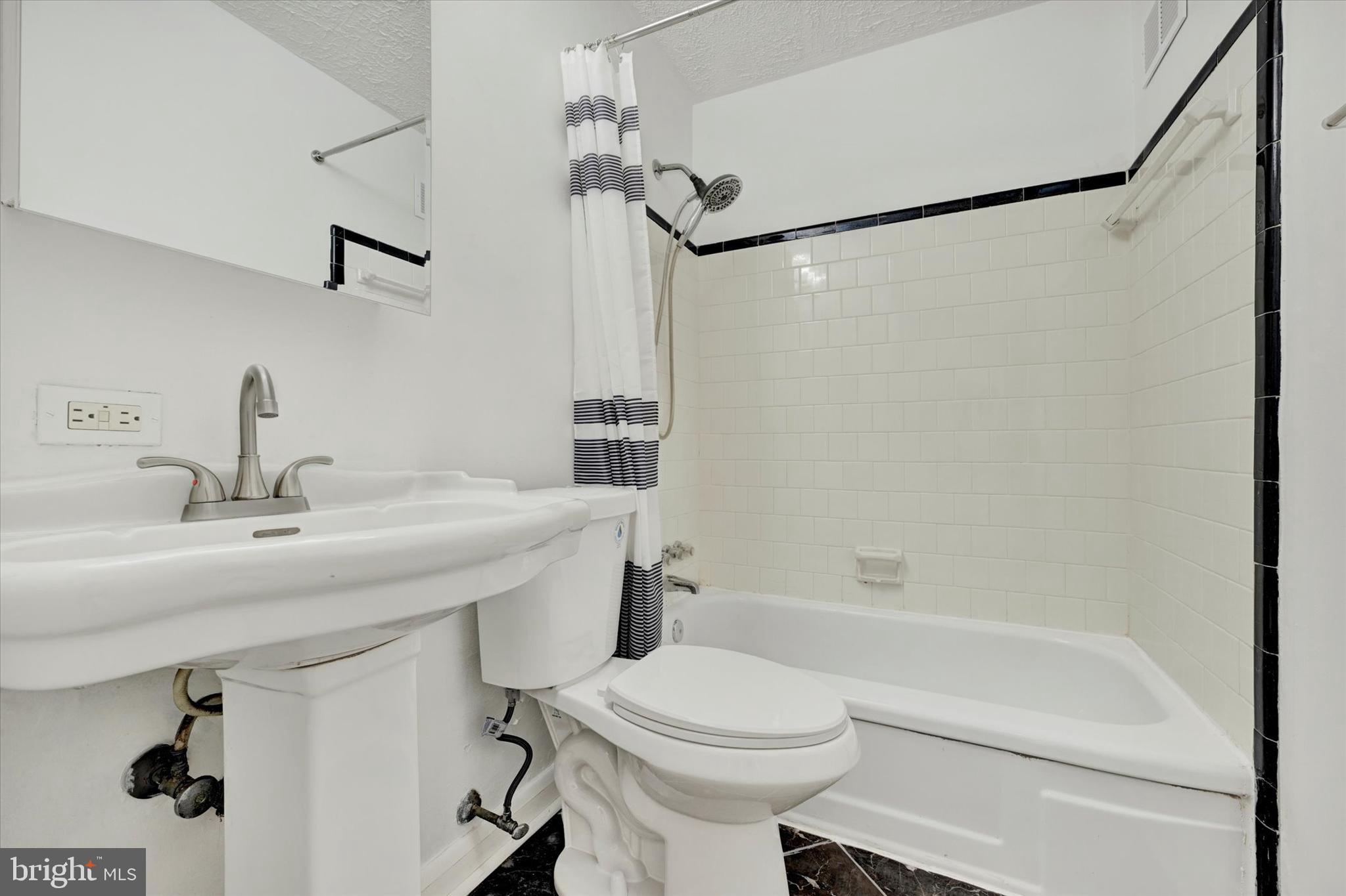 7007 Bank Street Baltimore, MD 21224 - Photo 12 of 18 a bathroom with a sink a toilet and shower