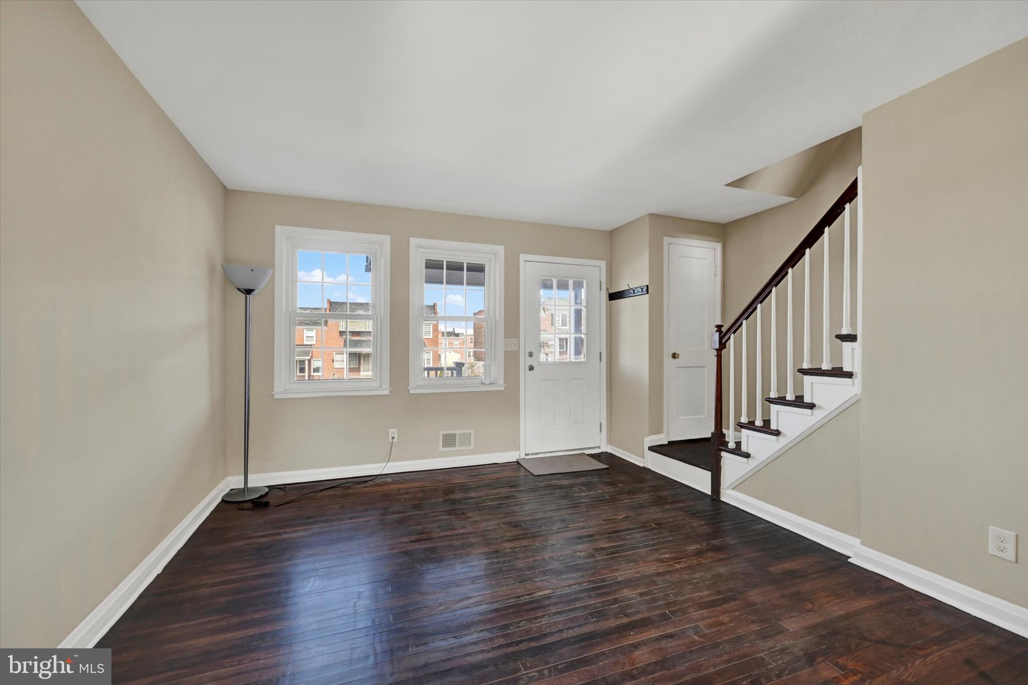 7007 Bank Street Baltimore, MD 21224 - Photo 2 of 18 a view of empty room with wooden floor and fan