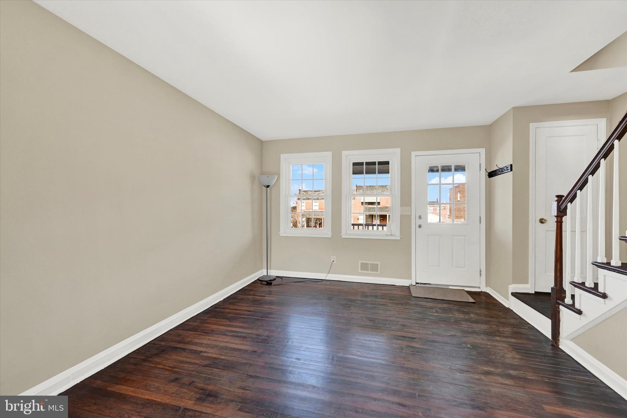 7007 Bank Street Baltimore, MD 21224 - Photo 3 of 18 an empty room with wooden floor and a window