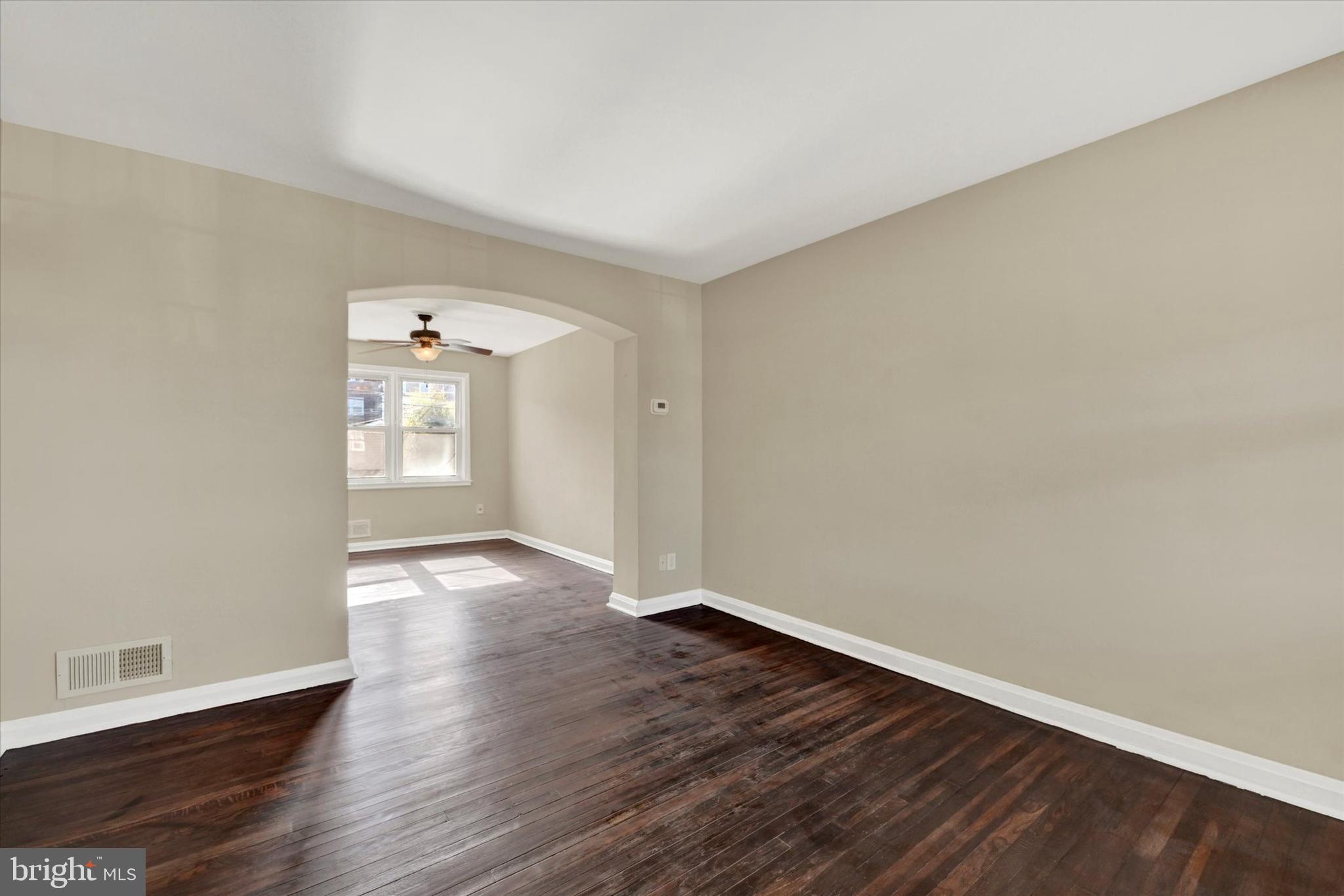 7007 Bank Street Baltimore, MD 21224 - Photo 4 of 18 an empty room with wooden floor and windows