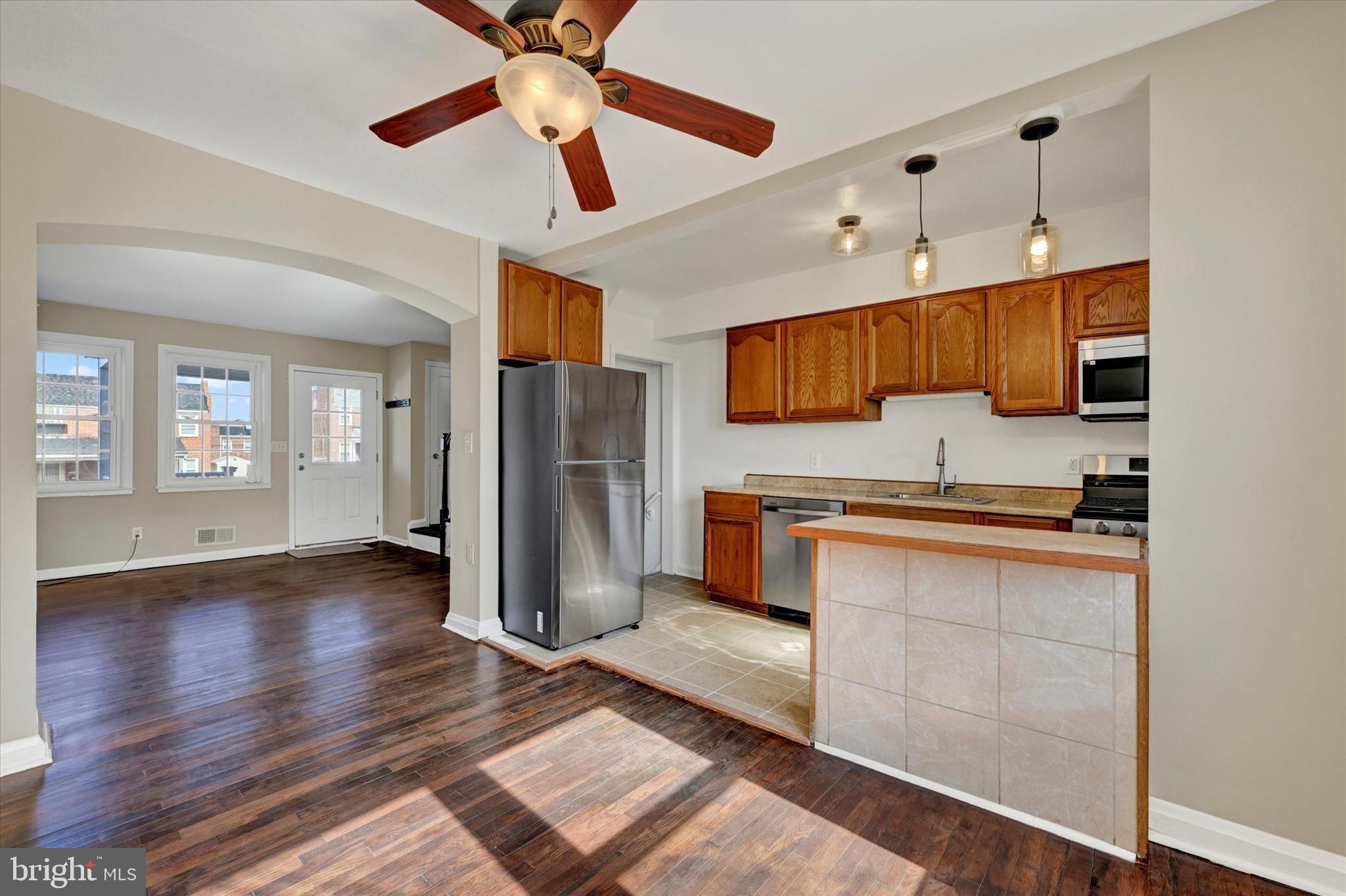 7007 Bank Street Baltimore, MD 21224 - Photo 6 of 18 a kitchen with stainless steel appliances a stove refrigerator and cabinets