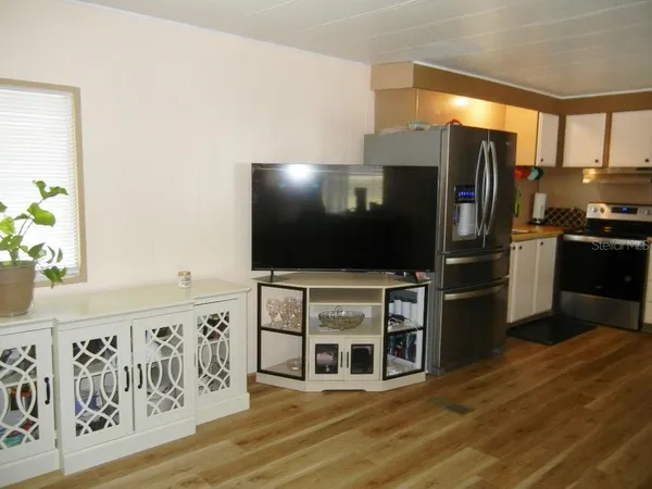 a kitchen with stainless steel appliances a refrigerator and a stove top oven