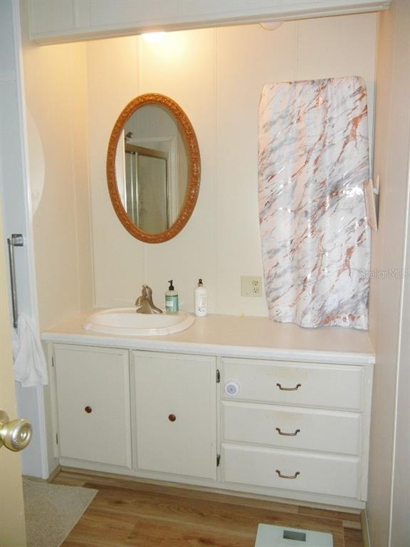 212 Rue De Pont Tavares, FL 32778 - Photo 19 of 36 a bathroom with a sink mirror and vanity