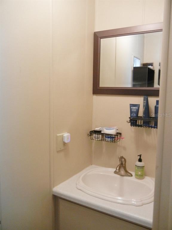 212 Rue De Pont Tavares, FL 32778 - Photo 27 of 36 a bathroom with a sink and a mirror