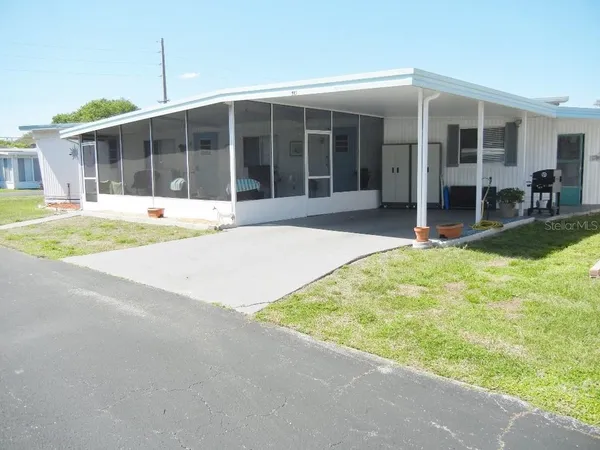 a view of a house with a backyard and porch