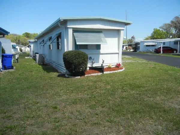 a view of a house with backyard and porch