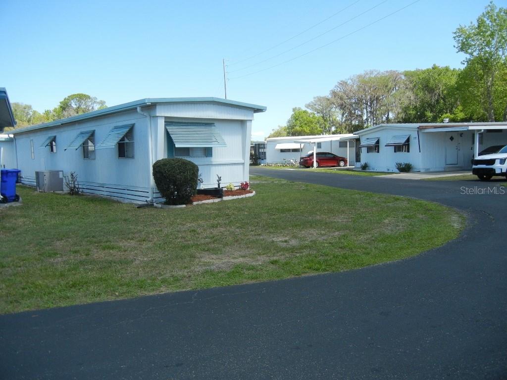 212 Rue De Pont Tavares, FL 32778 - Photo 33 of 36 a view of a house with a yard and sitting area