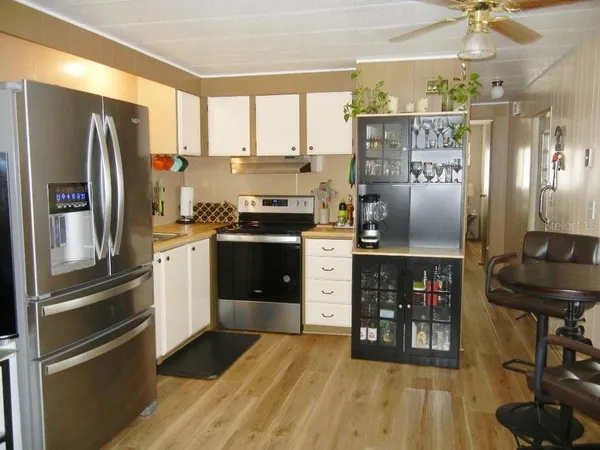 a kitchen with stainless steel appliances a refrigerator sink and microwave