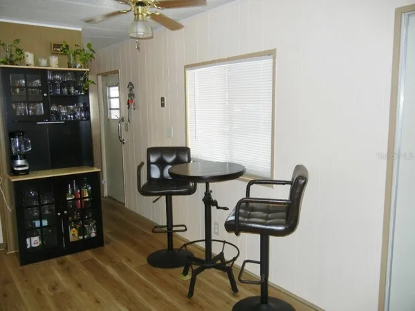 a view of a room with a table and chairs