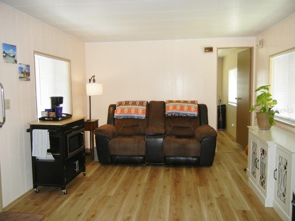 212 Rue De Pont Tavares, FL 32778 - Photo 10 of 36 a living room with furniture and a flat screen tv