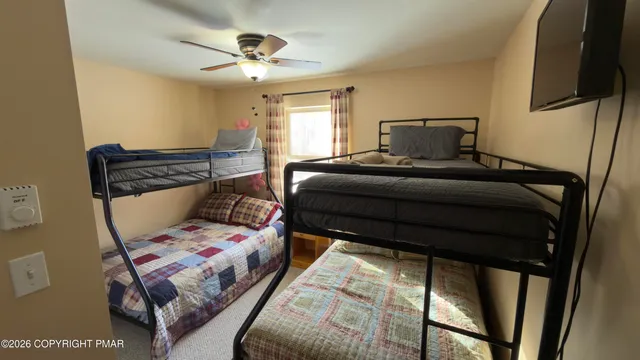 a bedroom with a bed and window