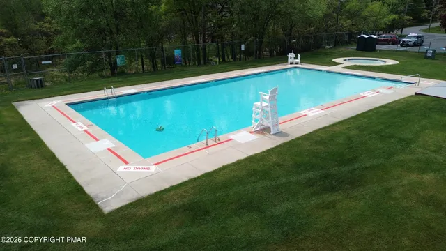 a view of a swimming pool with a yard