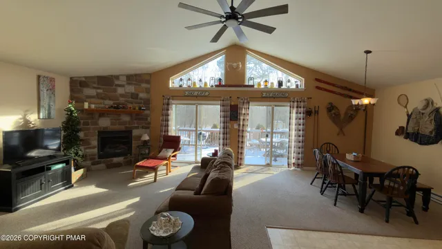 a living room with furniture a fireplace and a chandelier