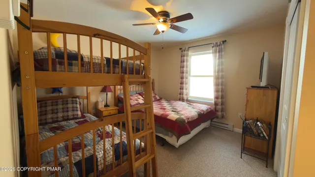 a bedroom with two beds and window