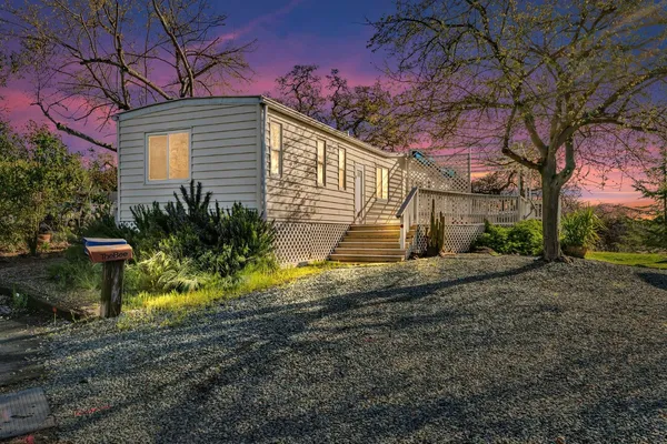 a kitchen with stainless steel appliances granite countertop a stove top oven a refrigerator and white cabinets with wooden floor