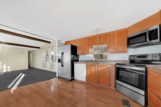 a kitchen with stainless steel appliances granite countertop a stove and a refrigerator