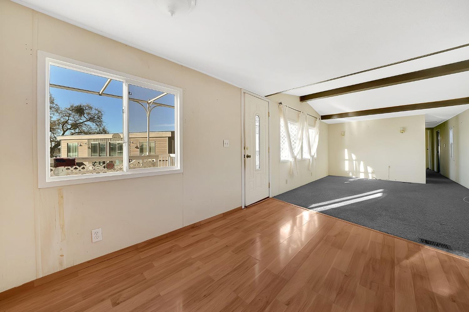 2000 Camanche Road, Unit 16 Ione, CA 95640 - Photo 14 of 36 a view of empty room with wooden floor and fan