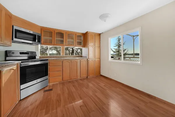 a view of empty room with wooden floor