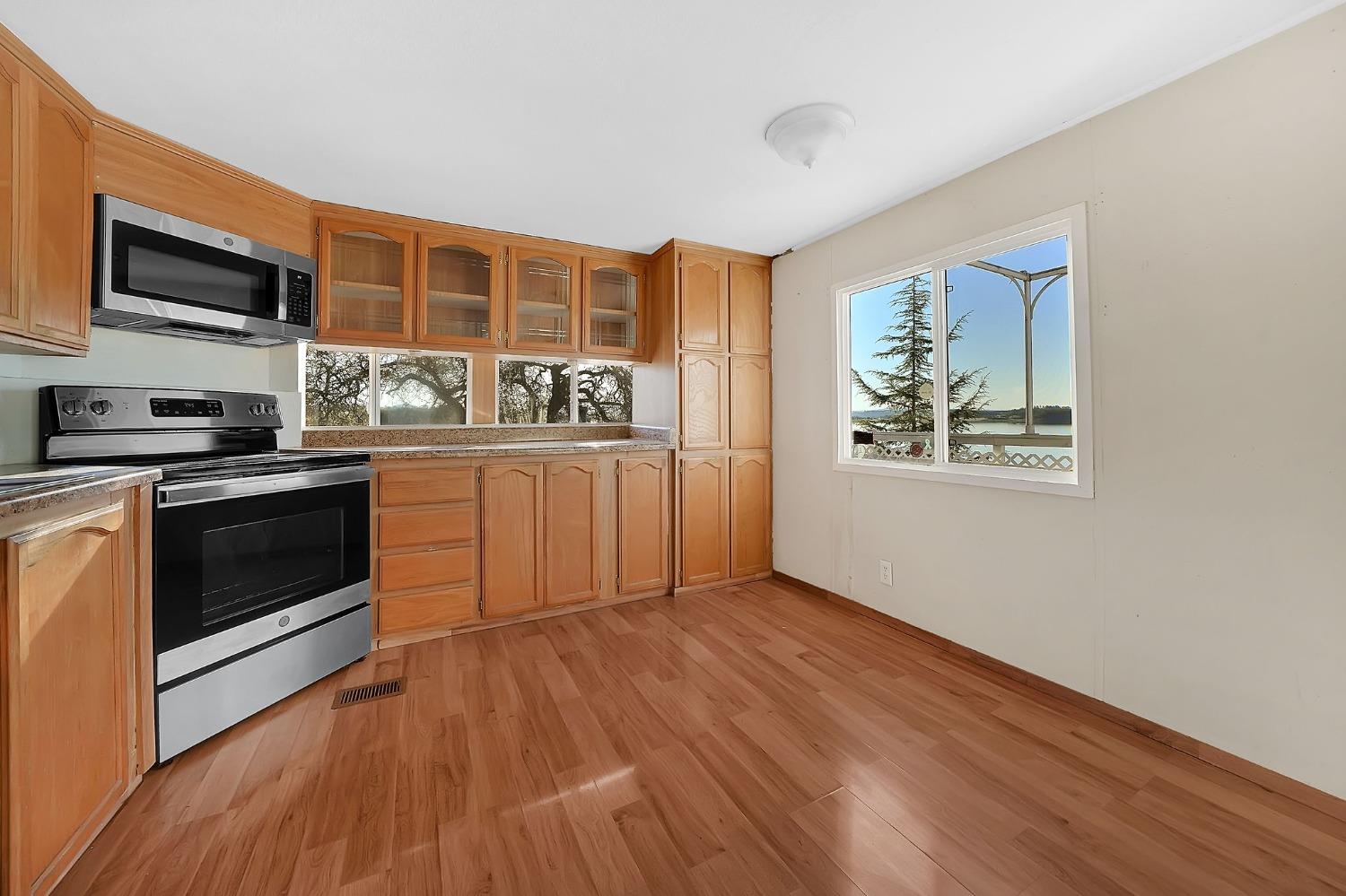 2000 Camanche Road, Unit 16 Ione, CA 95640 - Photo 15 of 36 a kitchen with stainless steel appliances granite countertop a stove and a refrigerator