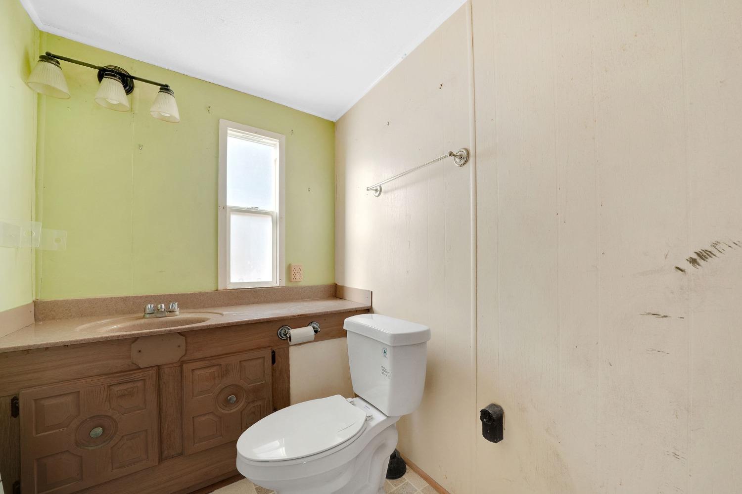 2000 Camanche Road, Unit 16 Ione, CA 95640 - Photo 21 of 36 a bathroom with a granite countertop toilet sink and mirror