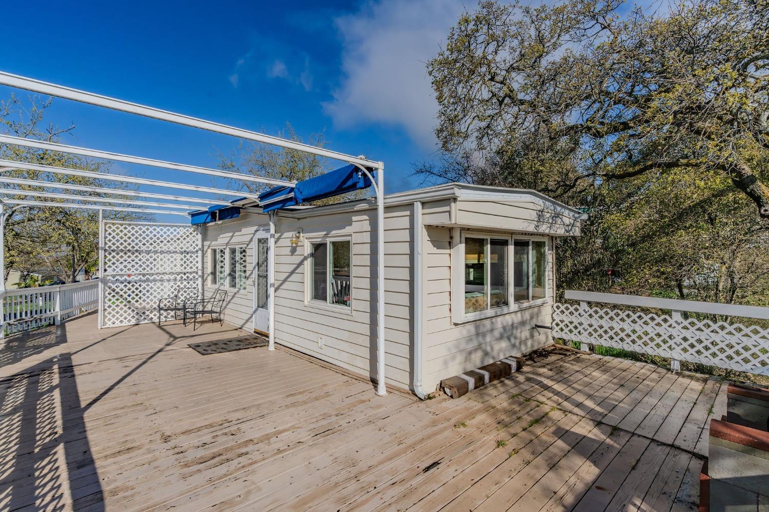 2000 Camanche Road, Unit 16 Ione, CA 95640 - Photo 27 of 36 a view of a house with wooden deck and furniture