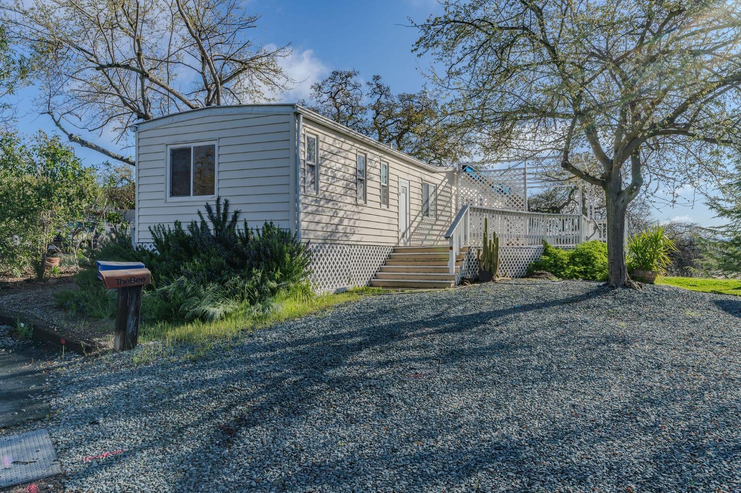 2000 Camanche Road, Unit 16 Ione, CA 95640 - Photo 6 of 36 a view of a backyard with plants and a slide