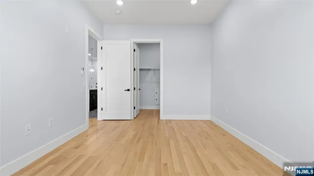 a view of a room with wooden floor
